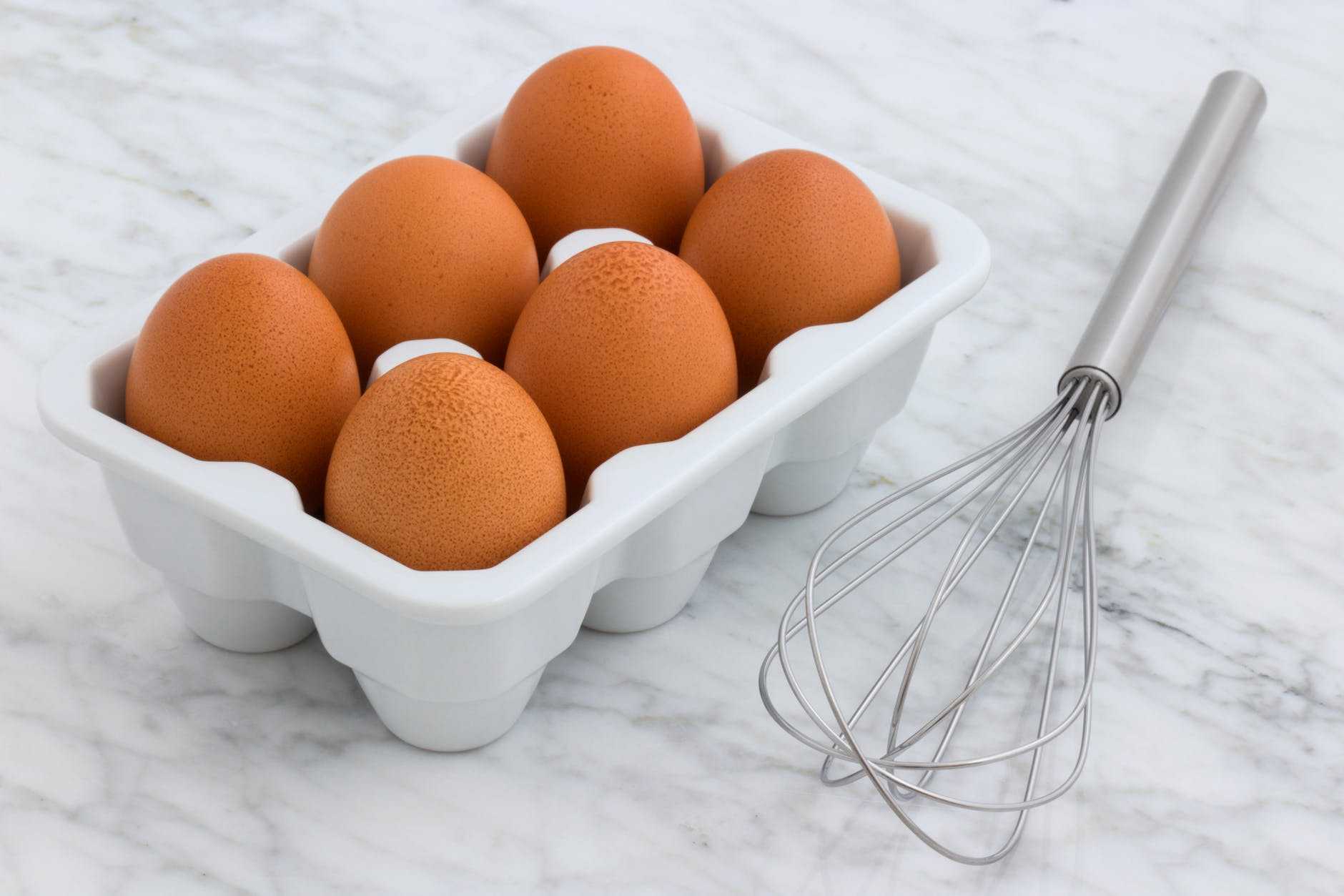 six brown eggs with tray